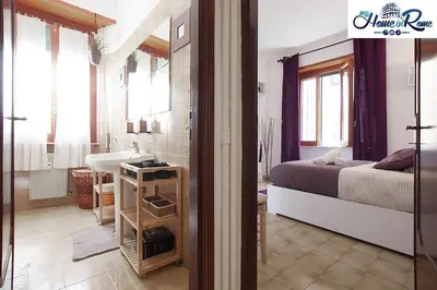 a bedroom with a bed and a bathroom with a sink at Holy Vatican Home in Rome