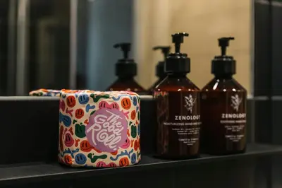 a group of four bottles of soap on a shelf at The Social Hub Rome Extended Stay in Rome