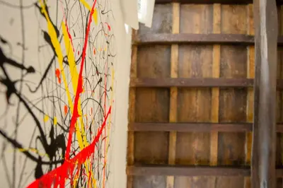 a wall with a red and yellow kite next to a ladder at Trastevere 2 Badrooms Design Appartment in Rome