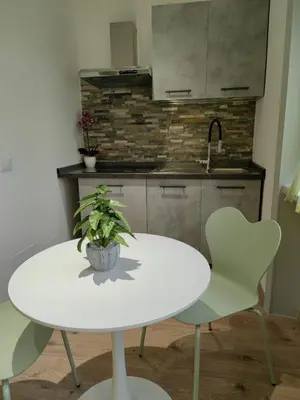 a white table and two chairs in a kitchen at B&B Gregorio VII in Rome