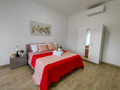 a bedroom with a bed with a red blanket at B&B Gregorio VII in Rome