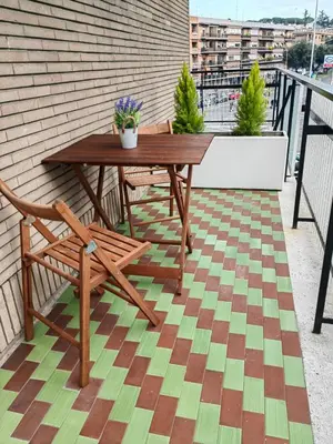 a wooden table and a bench on a balcony at B&B Gregorio VII in Rome