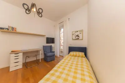 a bedroom with a bed and a desk and a chair at Elegant house in Monteverde in Rome
