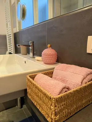 a bathroom with a basket next to a sink at Elegant house in Monteverde in Rome