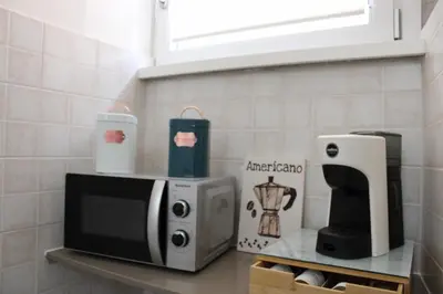 a kitchen counter with a microwave and a coffee maker at Apartment near the Vatican in Rome