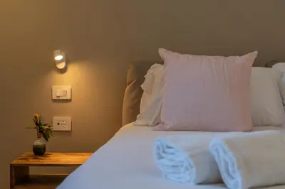 a bedroom with a bed with white sheets and pillows at Penthouse Vado Collection in Rome