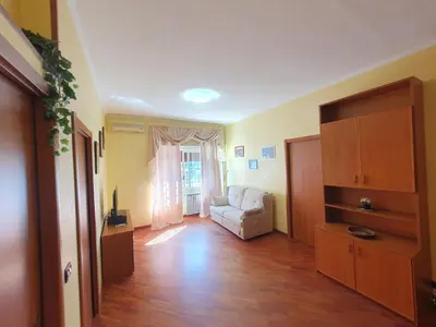 a living room with a white couch and a window at Domus Monteverde in Rome