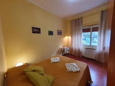 a bedroom with a bed with two pillows on it at Domus Monteverde in Rome