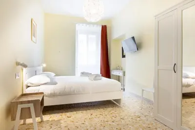 a white bedroom with a bed and a window at Casa Minieri - Viale Mazzini - San Pietro in Rome