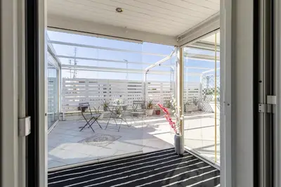 an open glass door to a balcony with a patio at Hostly-Salotti Terrace Suite-20min to Vatican in Rome