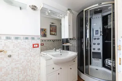a bathroom with a sink and a shower at Hostly-Salotti Terrace Suite-20min to Vatican in Rome