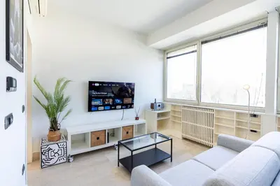 a living room with a couch and a tv at Urban Haven Roma, Porta Maggiore in Rome