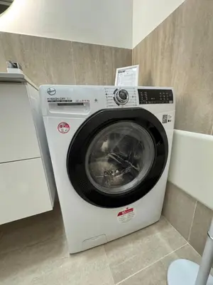 a white washing machine sitting in a room at Domus Romana Prati in Rome