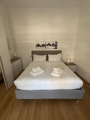 a bedroom with a bed with towels on it at Domus Romana Prati in Rome