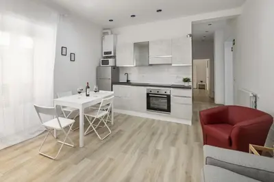 a kitchen with a white table and a red chair at central basic apartment in Rome