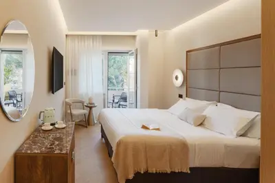 a bedroom with a large bed and a mirror at The Romex in Rome