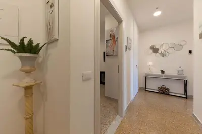a hallway with a mirror and a plant in a vase at auntieshouseroma in Rome