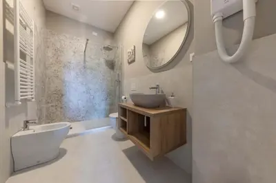 a bathroom with a sink and a toilet and a mirror at auntieshouseroma in Rome