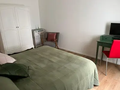a bedroom with a bed and a desk and a chair at The Rose Apt in Rome