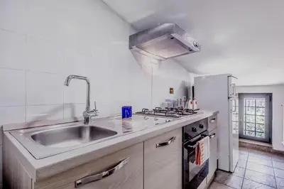 a kitchen with a sink and a stove at Ninkasi Bed and Beer Loft in Rome