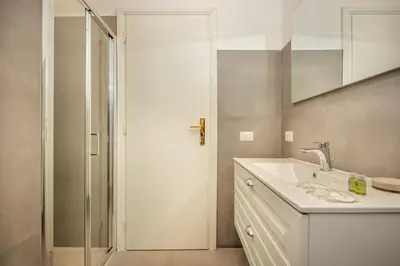 a bathroom with a white sink and a shower at Roma Borghese - casa vacanze in Rome