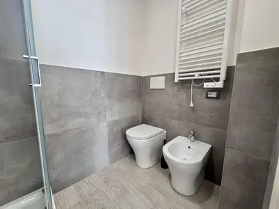 a bathroom with a toilet and a sink at Costabella Guest House in Rome