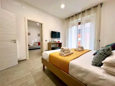 a bedroom with a large bed with towels on it at Costabella Guest House in Rome