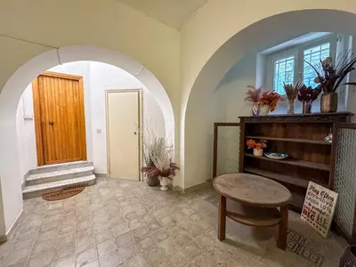 a room with an archway and a table and a door at Statilia 1 Apartment in Rome