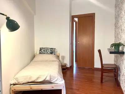 a small bedroom with a bed and a chair at Gandino House at Vatican in Rome