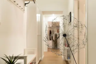 a hallway with a dandelion sculpture on the floor at PictaDomus-Albus, Metro Furio Camillo in Rome