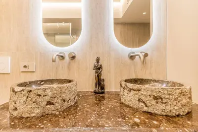 two sinks in a bathroom with two mirrors at Gianicolo Suites in Rome
