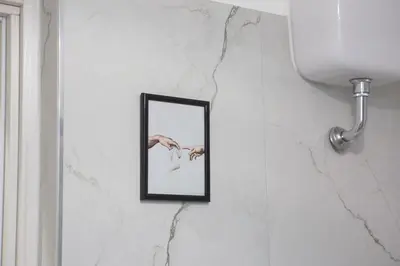 a picture of a hand in a mirror on a wall at Sunny's Suite - 8min from Colosseum in Rome