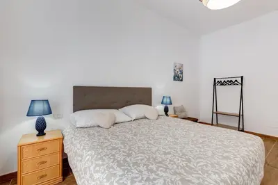 a bedroom with a large bed and two lamps at Apartment Vatican with 2 bathrooms and terrace in Rome