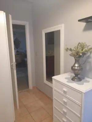 a vase with flowers on a dresser in a room at LIAM condo in Rome