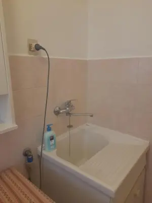 a bathroom with a bath tub with a faucet at LIAM condo in Rome