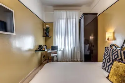 a hotel room with a bed and a table at Telier Ripetta in Rome