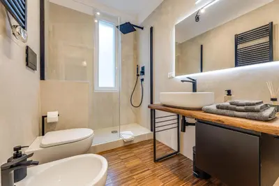 a bathroom with a sink and a toilet and a shower at La terrazza di Vanessa in Rome