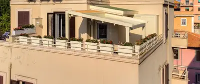 a balcony with potted plants on a building at La terrazza di Vanessa in Rome