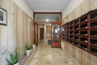 a hallway of a building with a door and some plants at 15 minuti da San Giovanni - A c, Wifi e Smart Tv in Rome