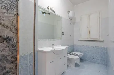 a bathroom with a sink and a toilet and a mirror at Dolce vita romana in Rome