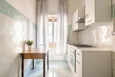 a white kitchen with a table and a table sidx sidx sidx at Dolce vita romana in Rome