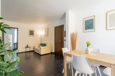 a dining room with a table and white chairs at Attico 4M - Ospedale Gemelli e Vista Panoramica by Hôtea in Rome
