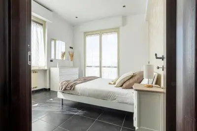 a white bedroom with a bed and a window at Attico 4M - Ospedale Gemelli e Vista Panoramica by Hôtea in Rome