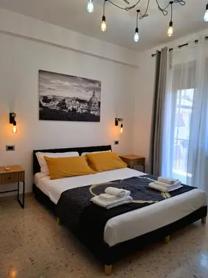 a bedroom with a bed with yellow pillows at Rome Lumina - Bilocale luminoso vicino Metro C, 6 fermate dal Colosseo in Rome