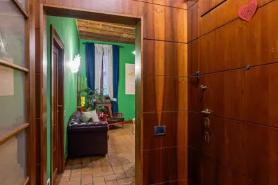 a hallway with green walls and a wooden door at Fico Giallo - Piazza Navona Apartment in Rome