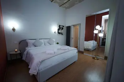 a bedroom with a large bed and a mirror at Bruno Domus Colosseo in Rome