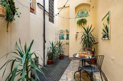 a small patio with a table and some plants at Green Central Rome Escape in Rome