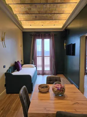 a living room with a bed and a table with a table at Train Station in Rome