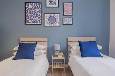 two beds sitting next to each other in a bedroom at B&F Home Vatican Stay in Rome