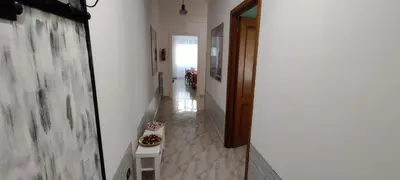 a hallway with a white wall and a table in a room at Malagrino House in Rome